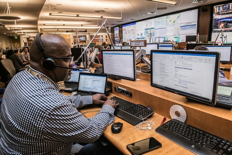 man in black and white checkered dress shirt using computer