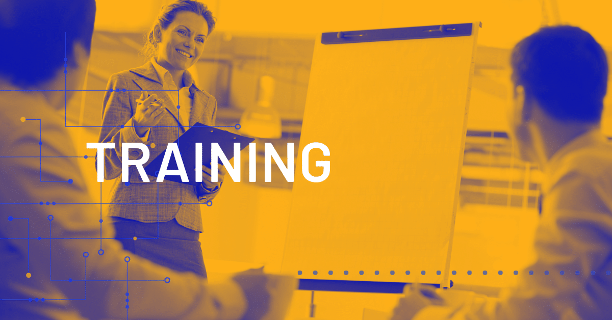 A woman stands by a blank flip chart holding a clipboard, leading a training session for two seated colleagues. The word TRAINING is displayed prominently across the image.